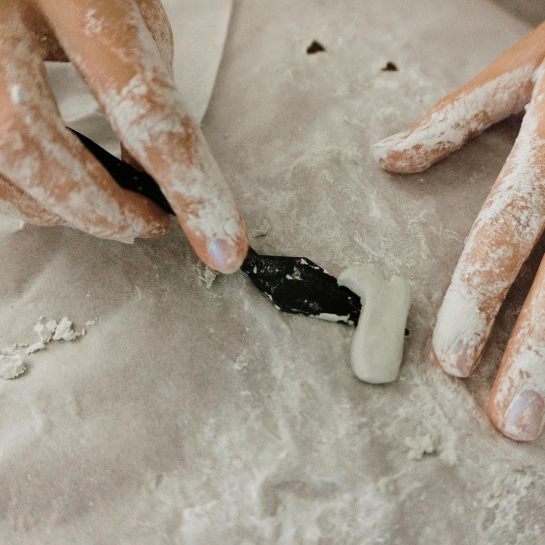 A photo of someone using their hands to work with clay