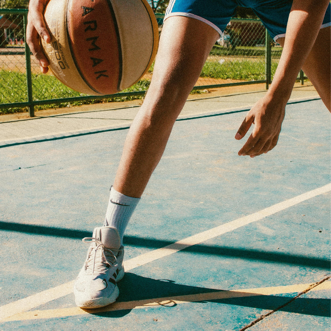 Photo of someone dribbling a basketball