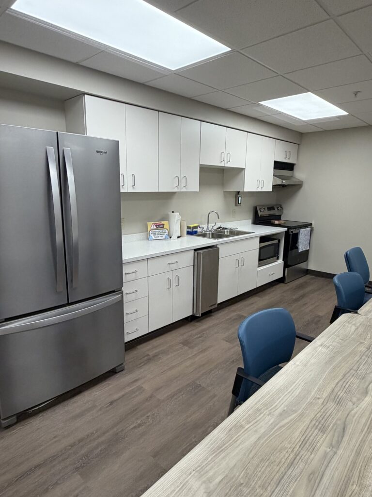 Kitchen in a lounge with a fridge and stove