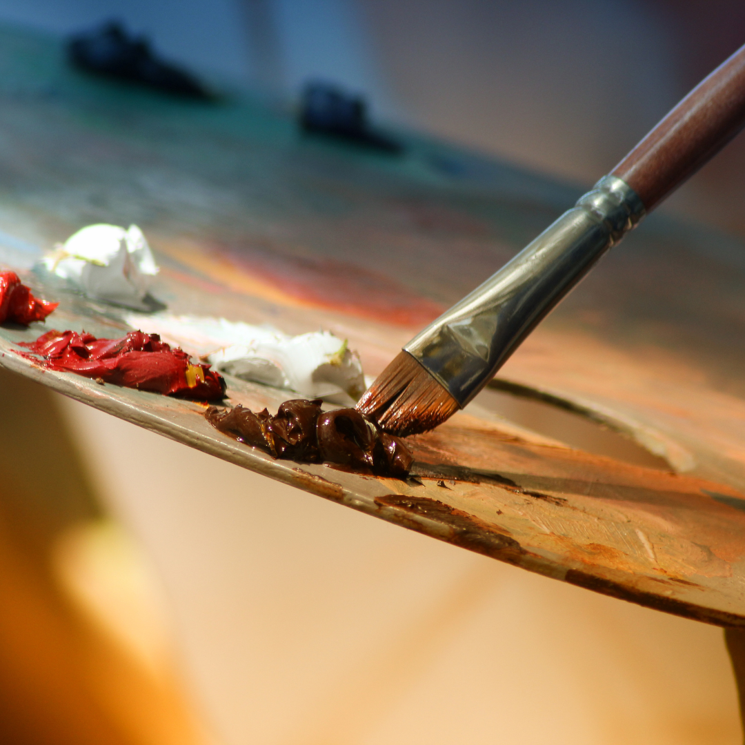 paintbrush dipping into paint
